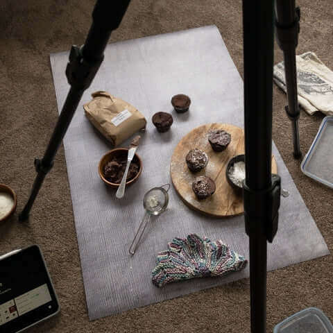 A photography setup featuring baked goods on a backdrop, perfect for showcasing products for buy backdrops nz.