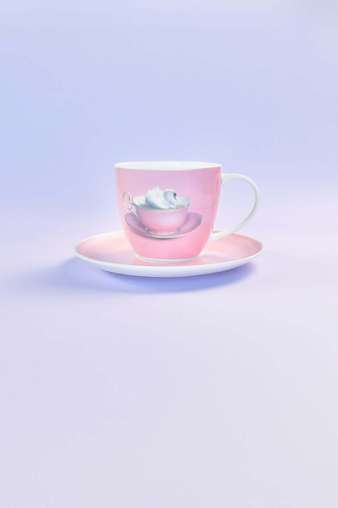 Pink teacup and saucer on a light purple background from CM Props & Backdrops 