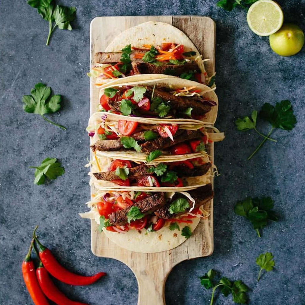 tacos on a board, presented on dark blue backdrop by CM Props & Backdrops 