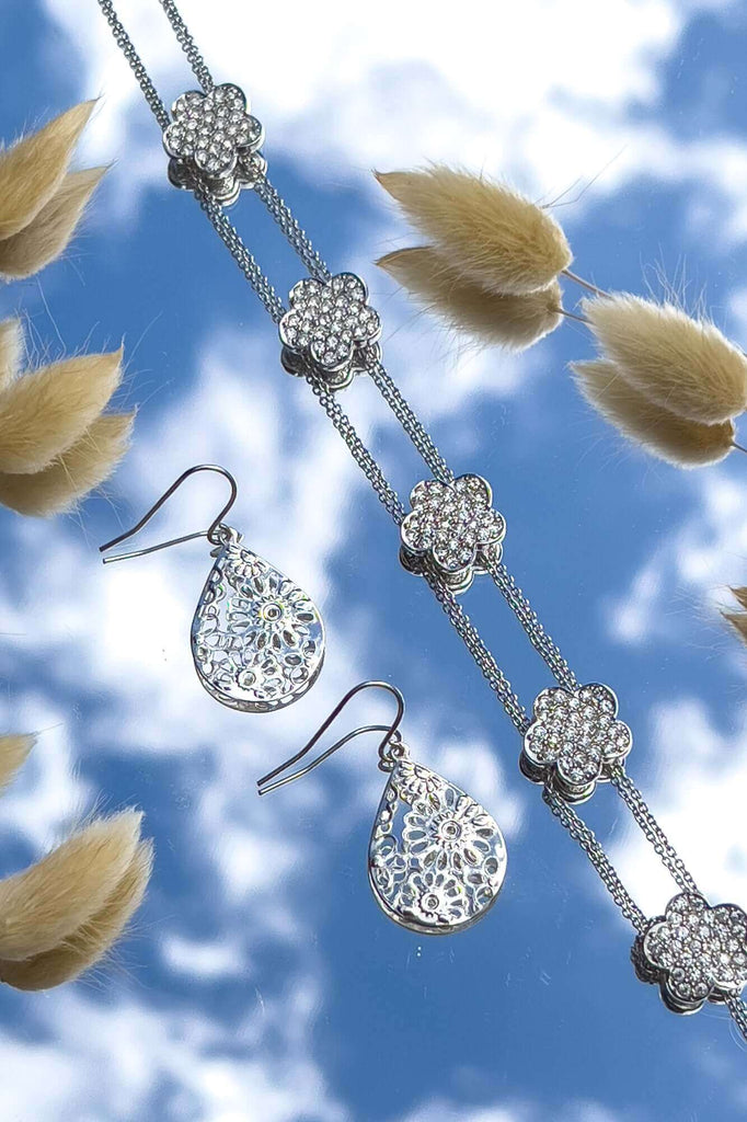 photo of jewellery on a mirror to show the sky as backdrop